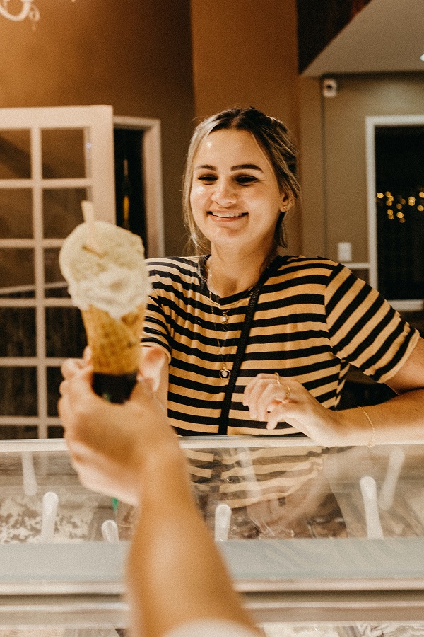 An Ice cream shop customer orders a coffee